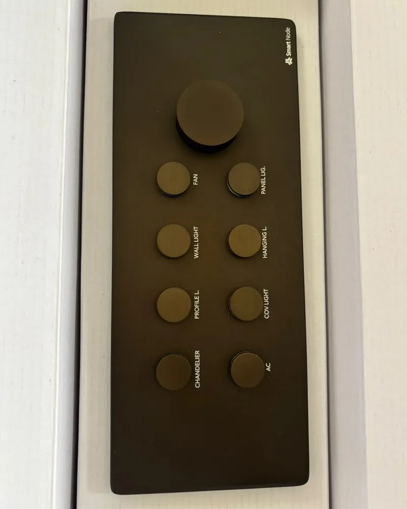 A Cosmos keypad in brushed bronze with a rotary knob and eight labelled buttons