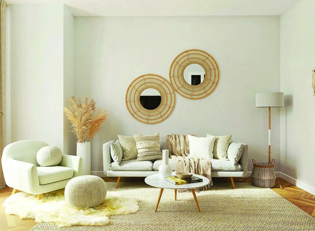 A bright living room with green walls, a low sofa and plants in afternoon light
